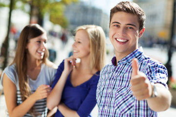 Young man showing thumbs up