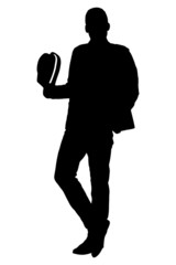 Silhouette of a young man holding a hat