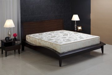 Nice and cozy spring mattress isolated in bedroom