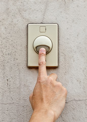 hand pressing doorbell