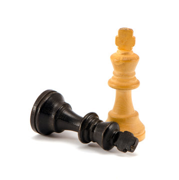 Black chess king lie near winner white legs