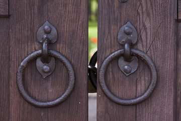 Closeup image of old door with circle iron door-handle