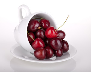 Ripe cherries in a coffee cup