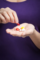 Woman takes painkillers, isolated on white. Medication