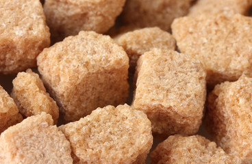 brown cane sugar cubes background close-up
