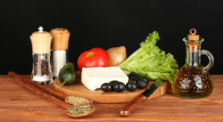 Ingredients for a Greek salad on black background
