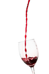 Glass filled with a red wine on white background