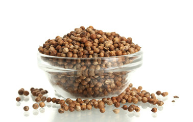Heap coriander seeds in glass bowl isolated on white