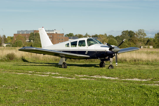Small plane with building at background