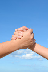 Partner hand between man and woman on blue sky, Teamworik