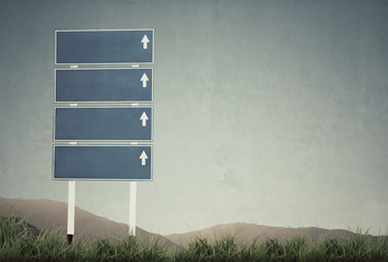 vintage picture of signpost with grass and blue sky