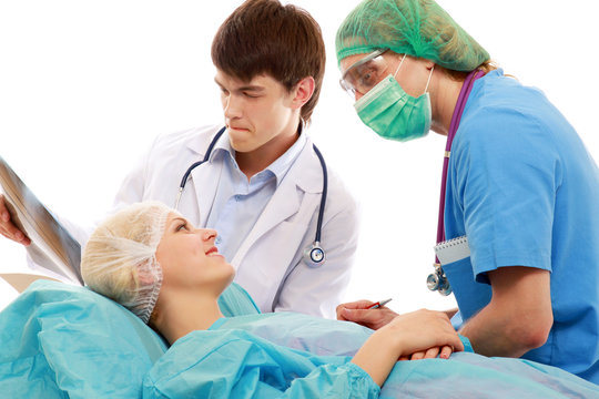 Male doctors talking to a female patient before