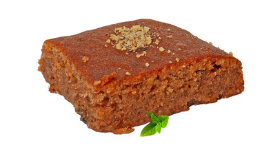 pecan pie with grated walnuts and syrup and basil leaves