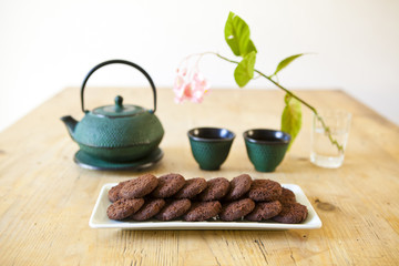 japanese tea with chocolate biscuits on wooden table