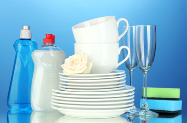 empty clean plates, glasses and cups with dishwashing liquid