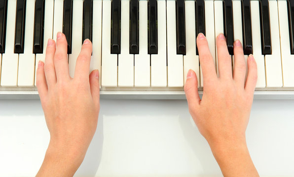 hands of woman playing piano
