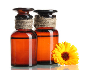 medicine bottles and beautiful calendula flower, isolated