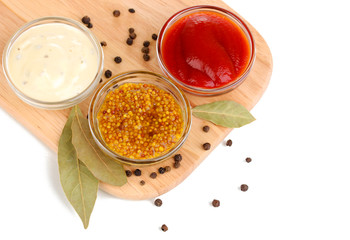 various sauces on chopping board isolated on white © Africa Studio