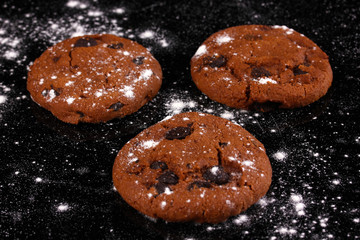 Chocolate chips cookies isolated on black