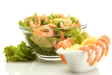 salad with shrimps, lemon and lettuce leaves in bowl and sauce,