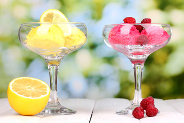 delicious ice cream on wooden table on bright background