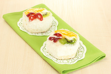 sweet cake with fruits on wooden table