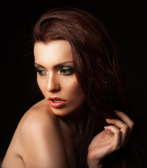 Fototapeta premium Beautiful woman with trendy makeup in a studio posing