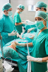 Nurse holding an oxygen mask next to a patient