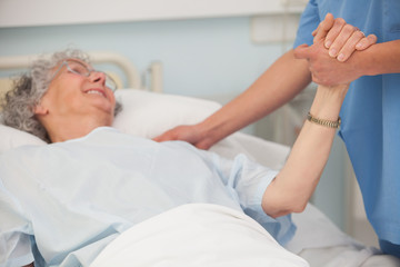 Obraz premium Elderly patient holding hand of nurse