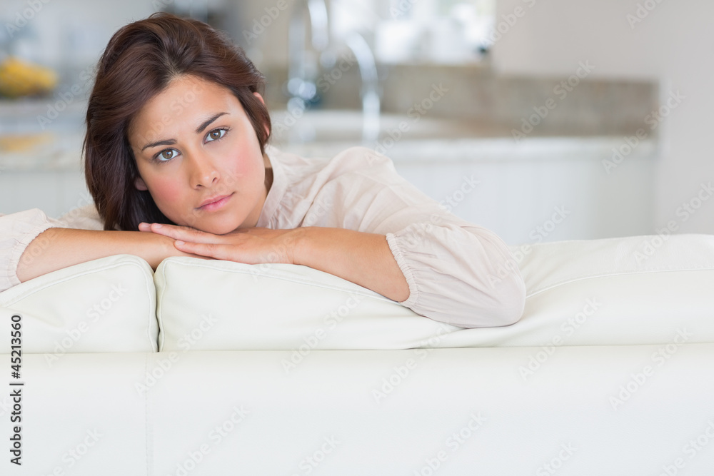 Wall mural Brunette relaxing on the couch