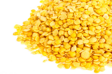 Yellow lentils isolated on white background. Macro shot