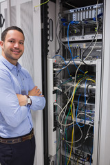 Smiling man standing in front of servers