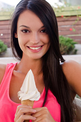 Beautiful girl smiling holding an ice cream