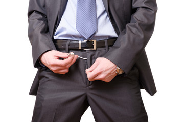 Young businessman mockingly pulling a usb cable off his pants.