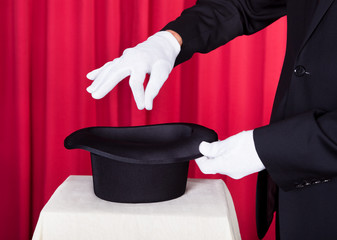 A Magician Performing Magic With Hat