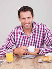 Portrait Of Young Man Having Breakfast