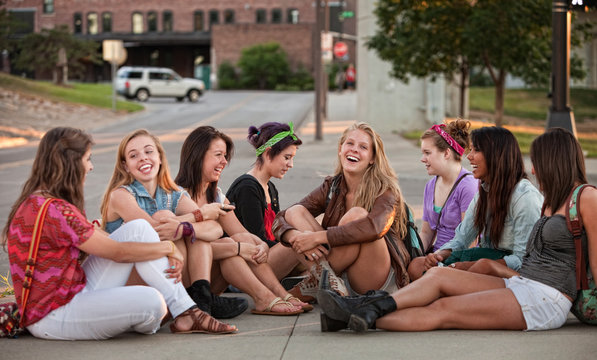 Eight Pretty Girls Sitting Outdoors