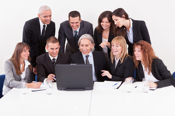 Businessman Showing On Laptop In Meeting