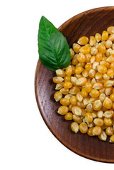 Plate with grain corn and basil leaf