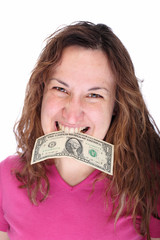 Young woman biting dollars by his teeth