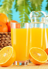 Composition with two glasses of orange juice and fruits