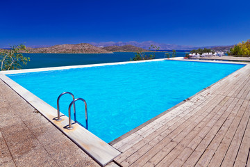 Fototapeta premium Blue swimming pool at Mirabello Bay in Greece