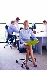 Fototapeta premium business woman with her staff in background at office