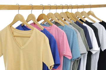 Variety of casual shirts on wooden hangers