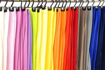 line of many colorful pants on the hanger