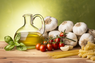 still life with olive oil,vegetables on wood table