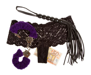 Fluffy purple handcuffs, a whip, money and panties, prostitution