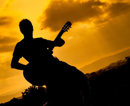 playing guitar at sunset
