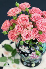Beautiful fresh roses on a dark background .