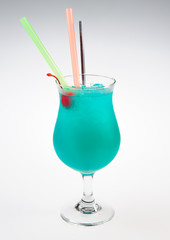 Blue alcoholic cocktail over white background